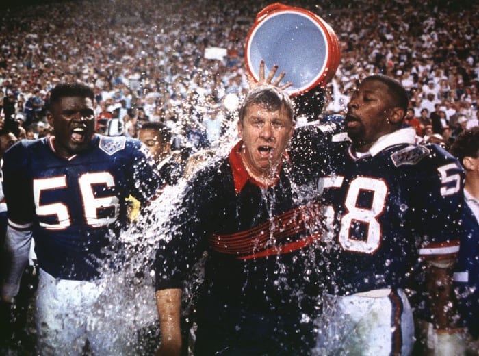 Giants linebackers Lawrence Taylor, left, and Carl Banks, right, douse head coach Bill Parcells with Gatorade after winning Super Bowl XXV.